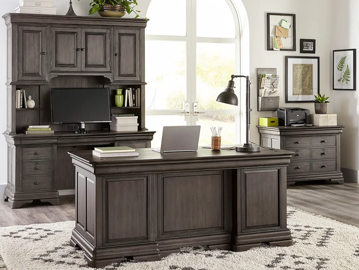 Stunning office featuring a dark wooden desk. 