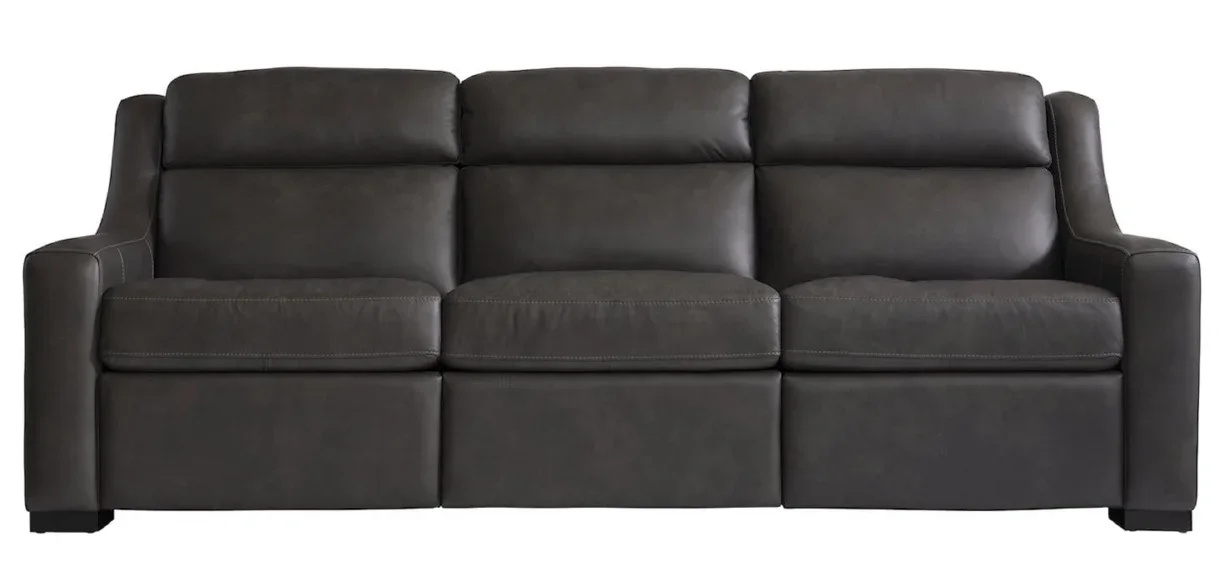 Brown leather reclining sofa against a plain white background. 