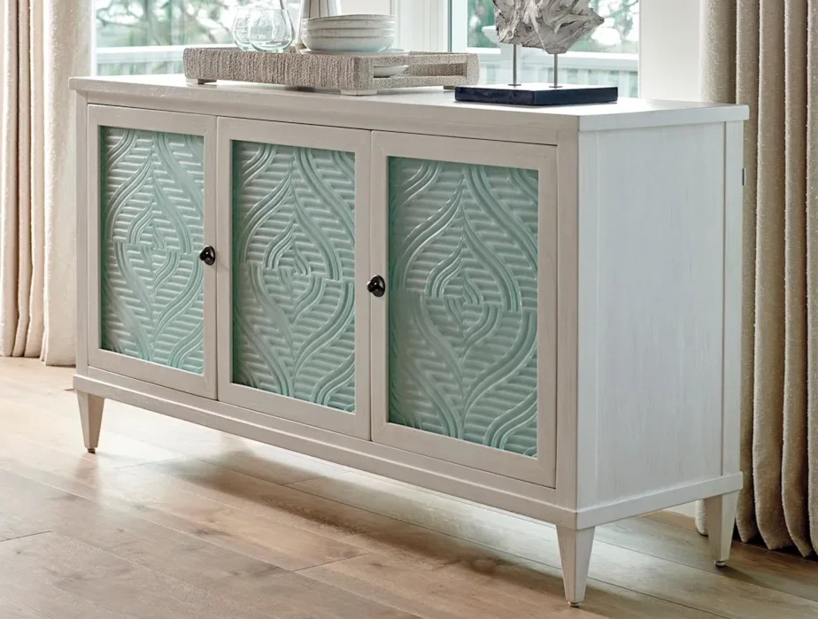 white-washed buffet with light blue-green glass doors. 