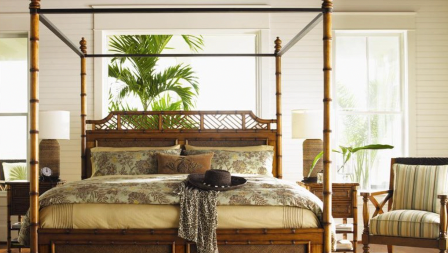 Bamboo and rattan canopy bed in a tropical bedroom. 