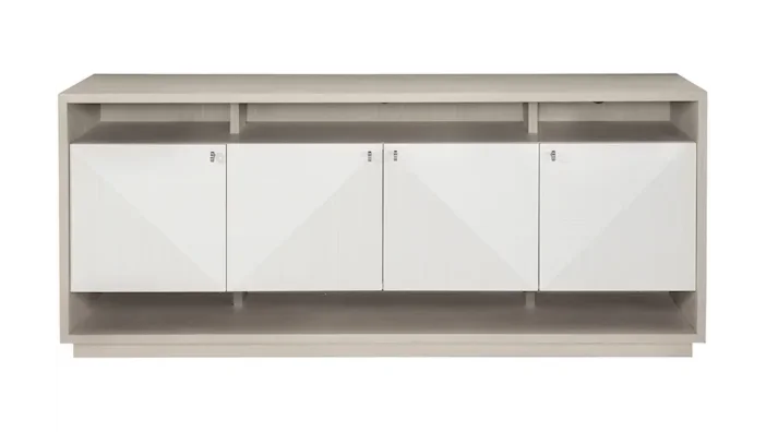 Minimalist white and neutral tone console with four cabinets and open compartments above and below the doors. 