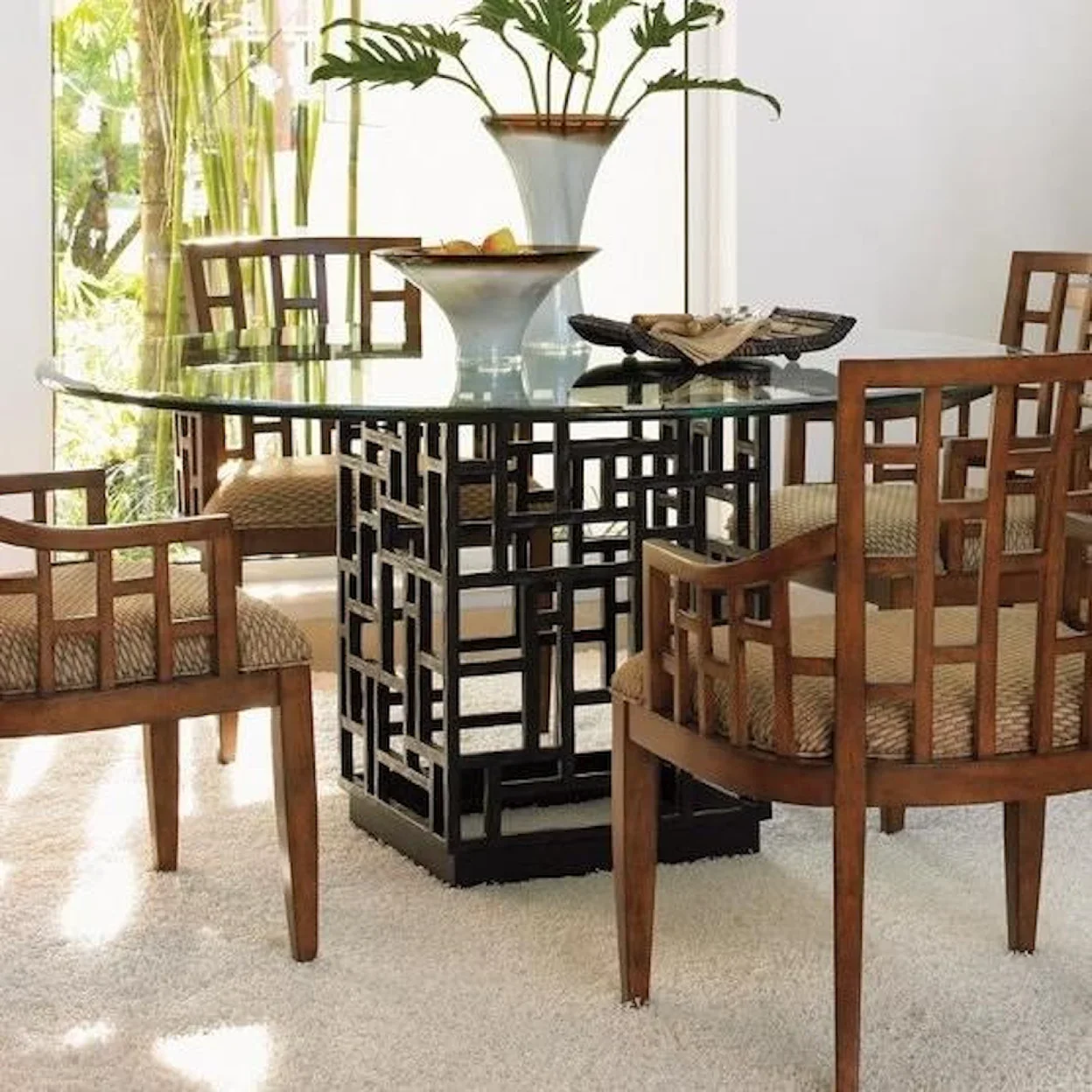 Light wood chairs around a glass table. 