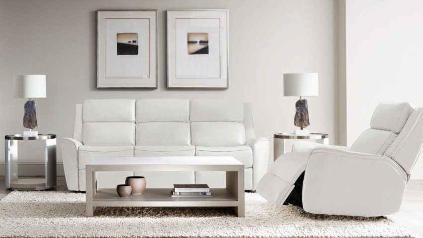 White leather recliner and reclining sofa in minimalist living room. 