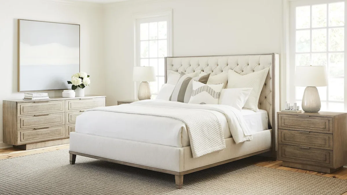 Contemporary padded bed with tufted headboard.