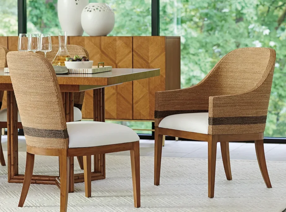 Two rattan chairs at the end of a table. 