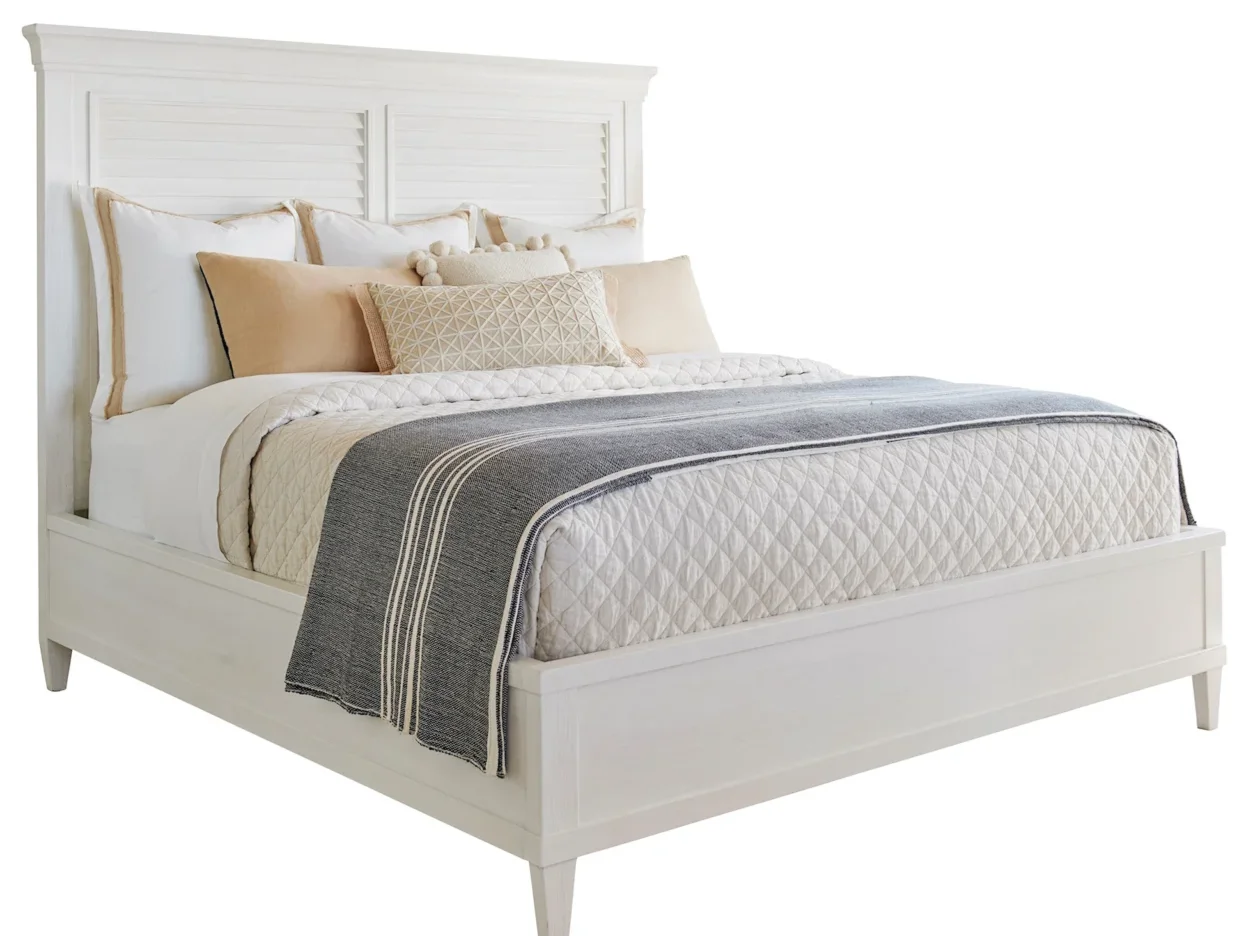White panel bed with wooden slats in the headboard. 