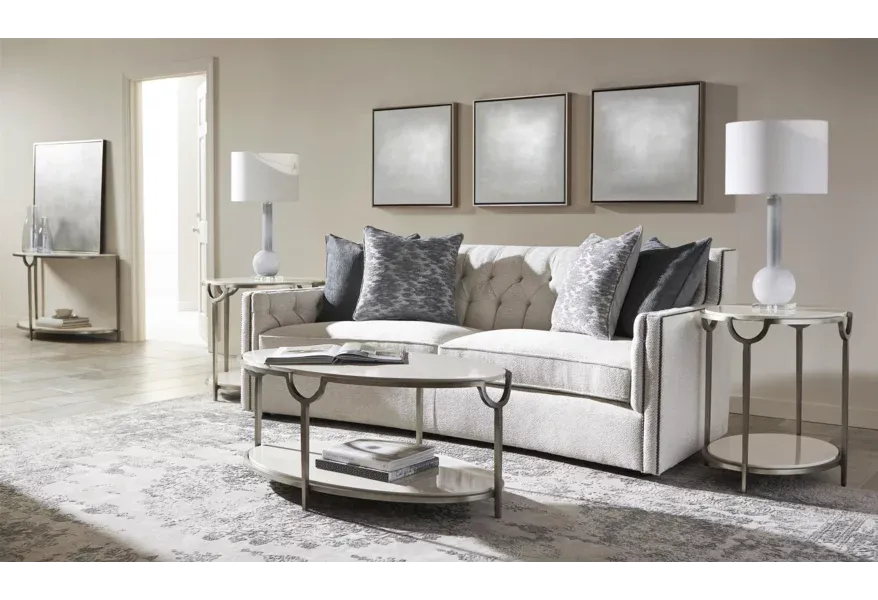 Curved sofa with nailhead trim in living room.