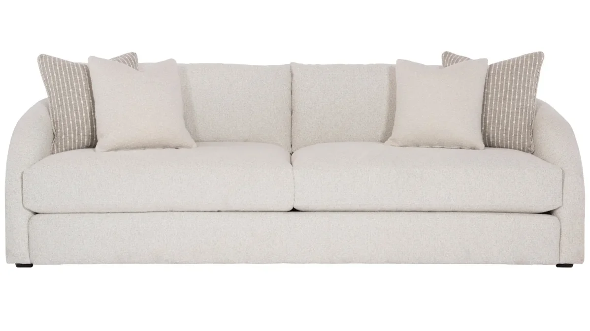 Off-white fabric sofa with throw pillows. 