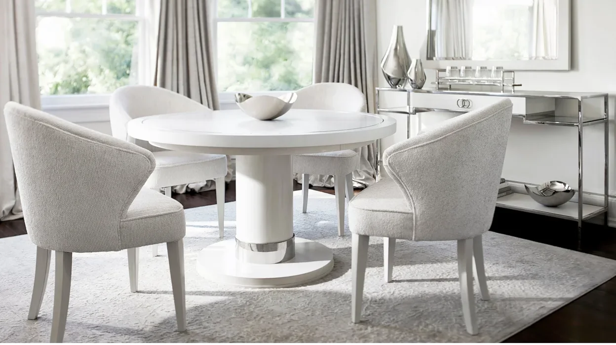 White table with contemporary chairs in a small dining area. 