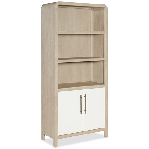 light wood tone bookcase with concealed storage below behind white doors