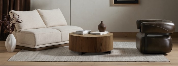 Living room set with loveseat, accent chair and coffee table with books on top