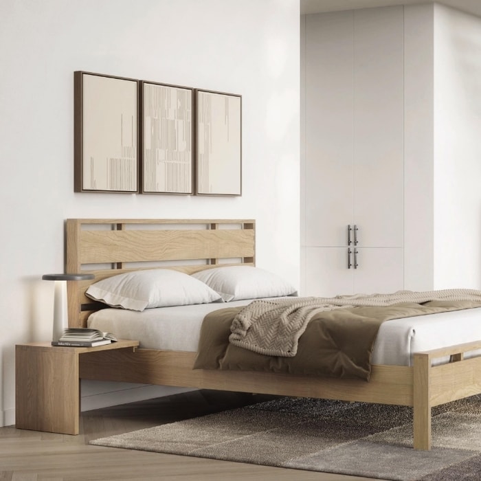 Bedroom set with wooden bed, nightstand and chest of drawers with white bedding and a rug. 