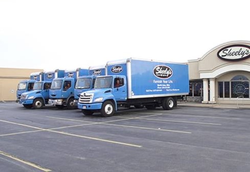 Sheely's delivery trucks parked in front of the building.