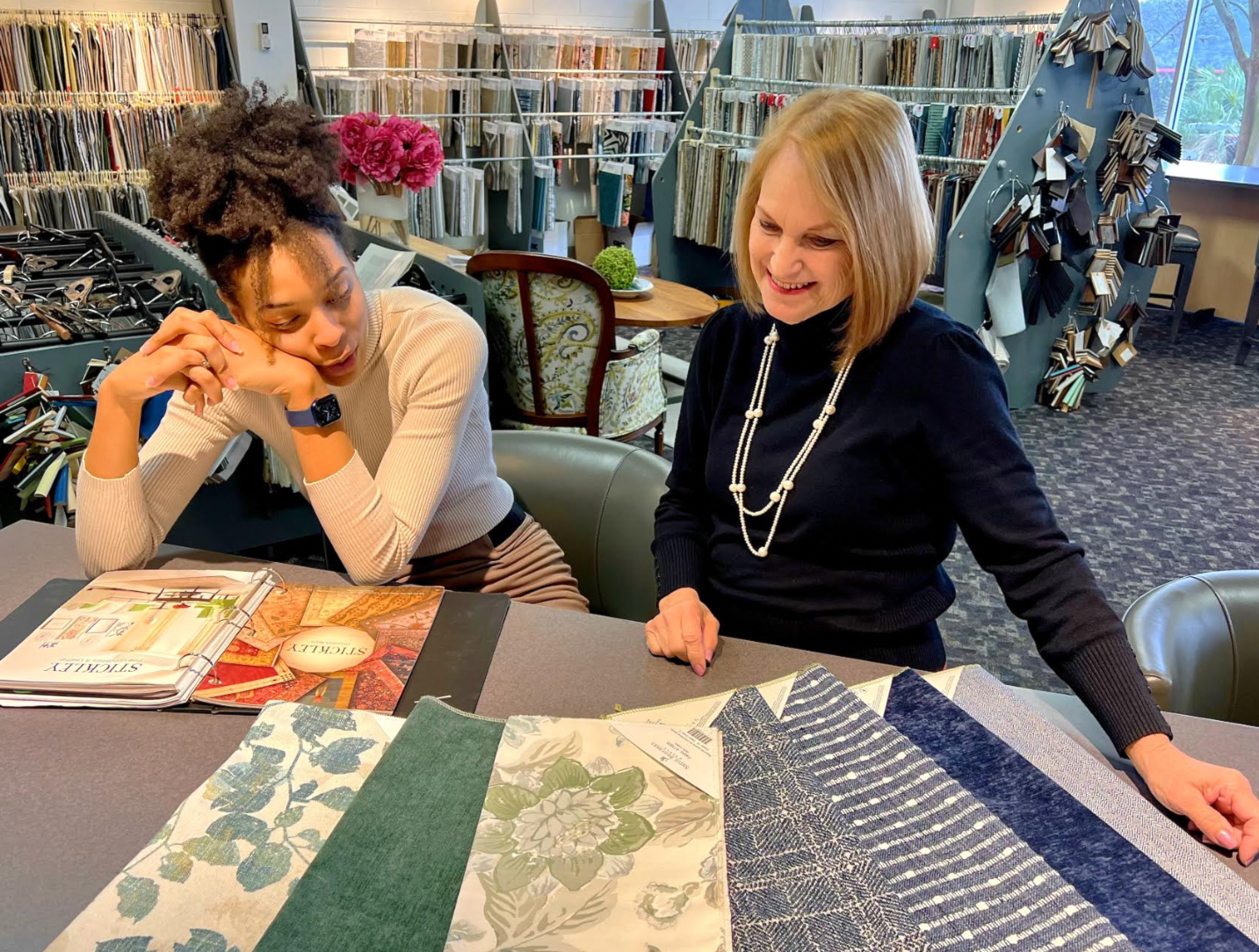 Designer showing fabric to a client