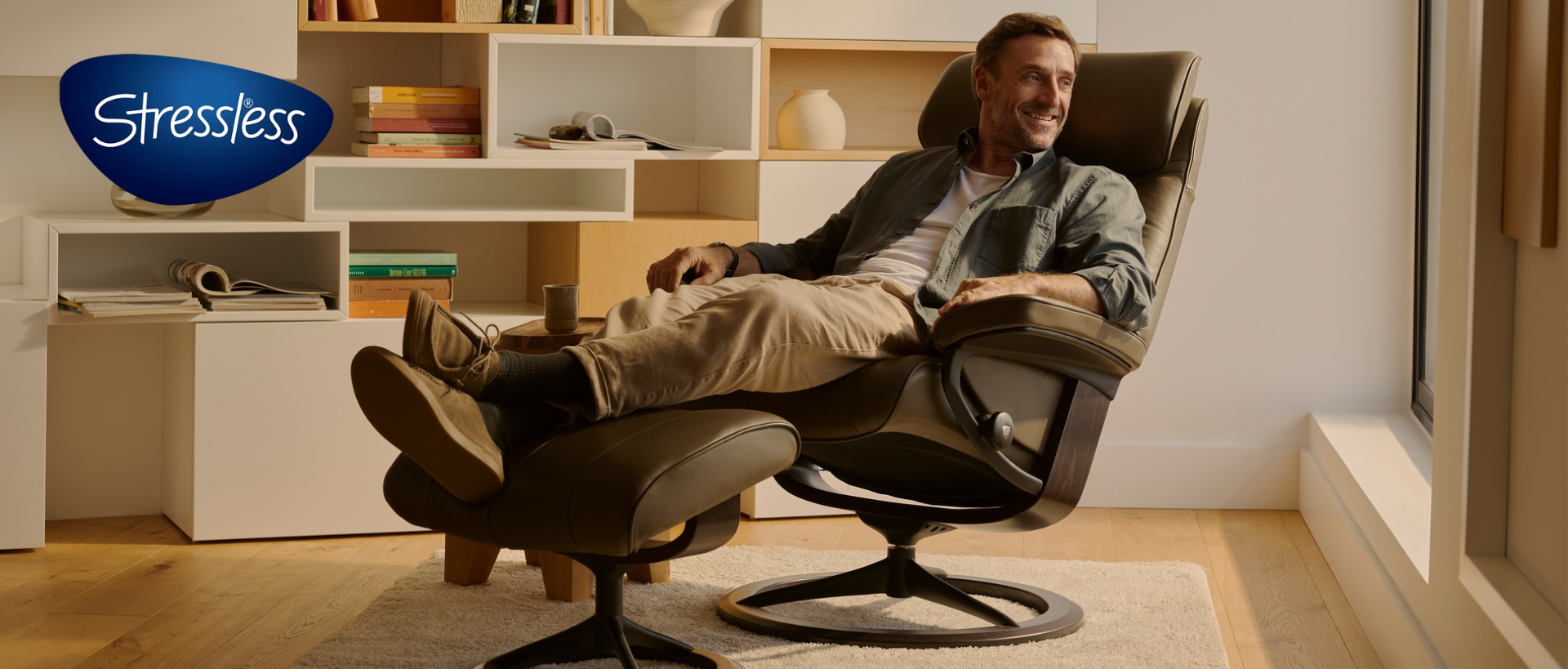 Man sitting in a reclining chair and ottoman set from Stressless