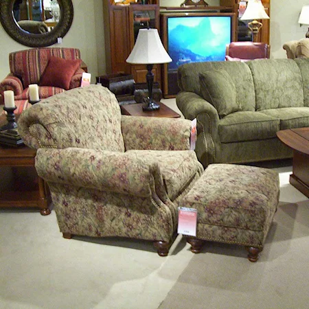 Rolled arm chair and ottoman with nail head trim